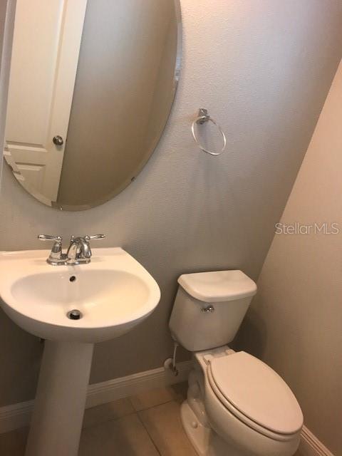 8549 Pinter Street Orlando, FL 32827 - Photo 17 of 25 a white toilet sitting next to a bathroom sink