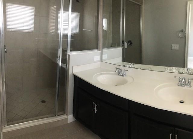 8549 Pinter Street Orlando, FL 32827 - Photo 19 of 25 a bathroom with a sink double vanity and a mirror