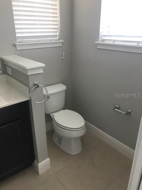 8549 Pinter Street Orlando, FL 32827 - Photo 20 of 25 a white toilet sitting in a bathroom next to a window