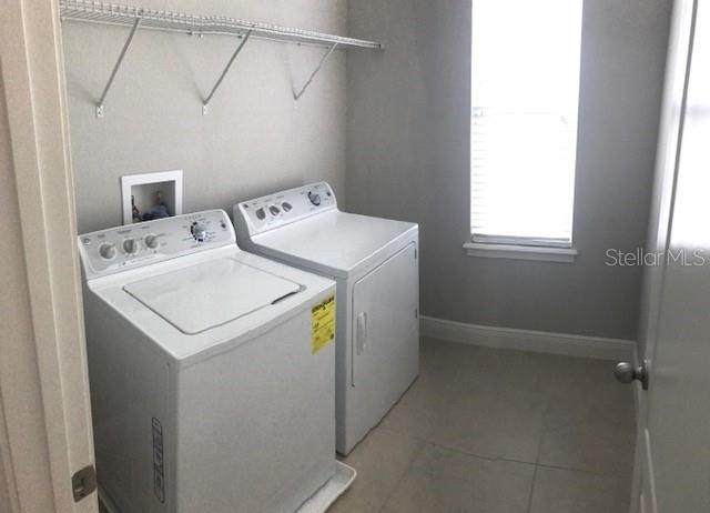 8549 Pinter Street Orlando, FL 32827 - Photo 22 of 25 a utility room with dryer and washer