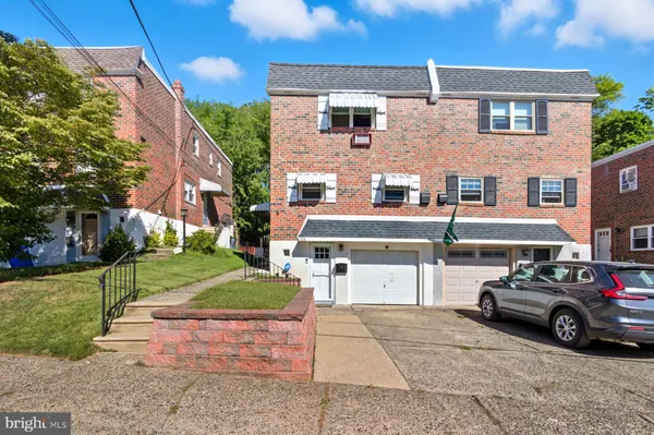 a car parked in front of a brick house