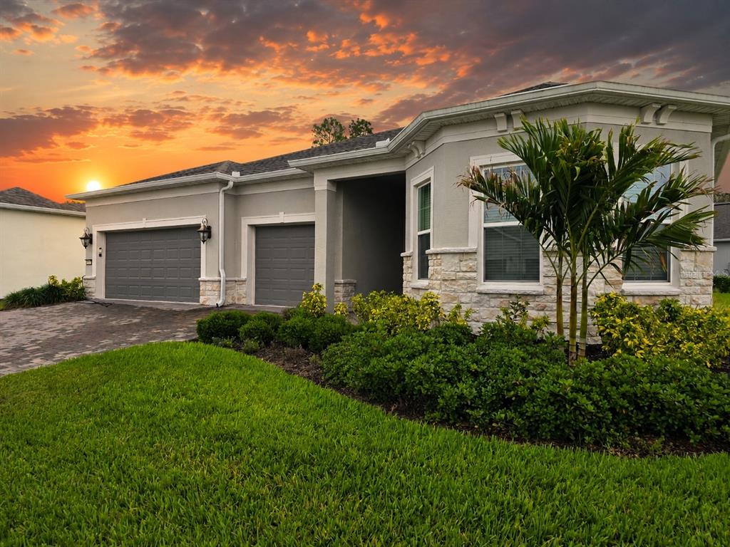 6349 Mossy Oak Road St. Cloud, FL 34771 - Photo 1 of 82 a front view of a house with a garden