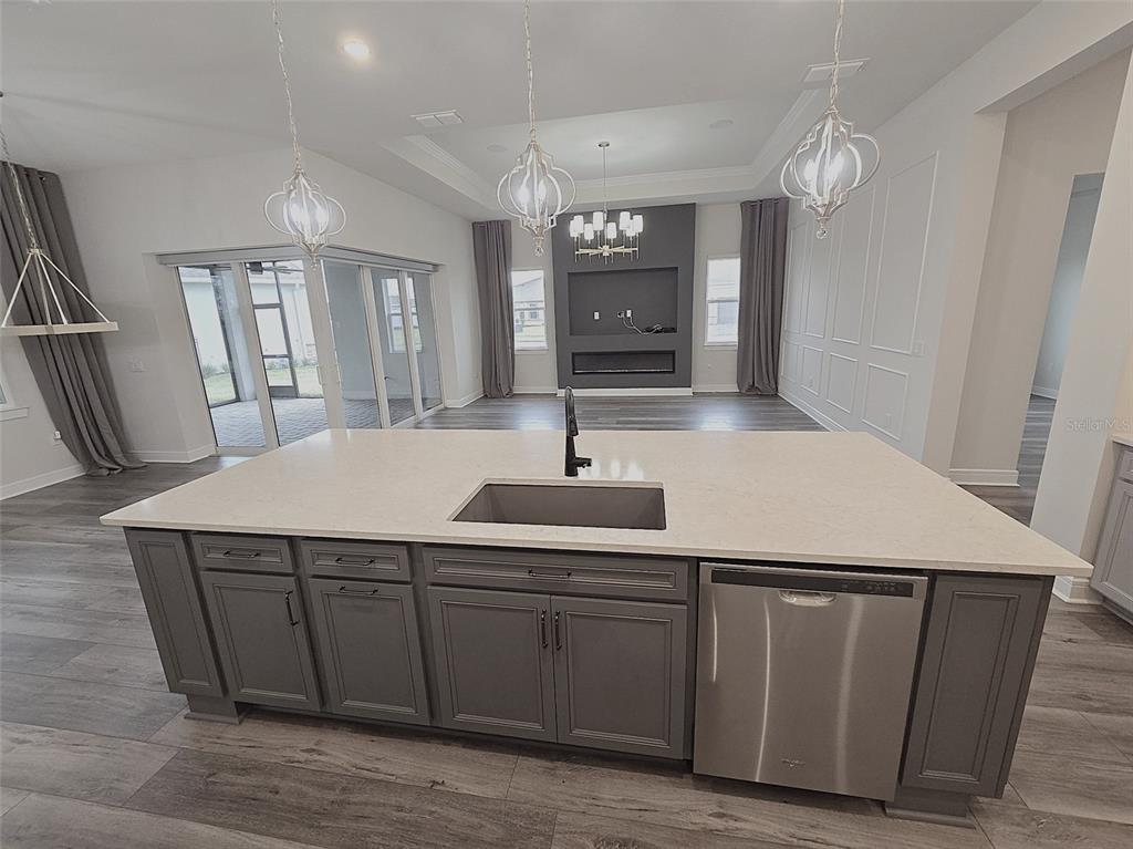 6349 Mossy Oak Road St. Cloud, FL 34771 - Photo 13 of 82 a kitchen with a sink a counter space and cabinets