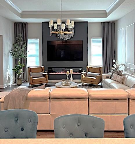 6349 Mossy Oak Road St. Cloud, FL 34771 - Photo 14 of 82 a living room with furniture chandelier and a flat screen tv