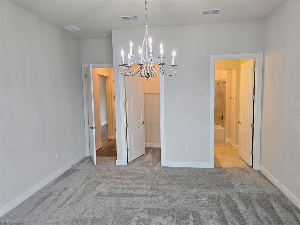 6349 Mossy Oak Road St. Cloud, FL 34771 - Photo 18 of 82 a view of a chandelier in a room