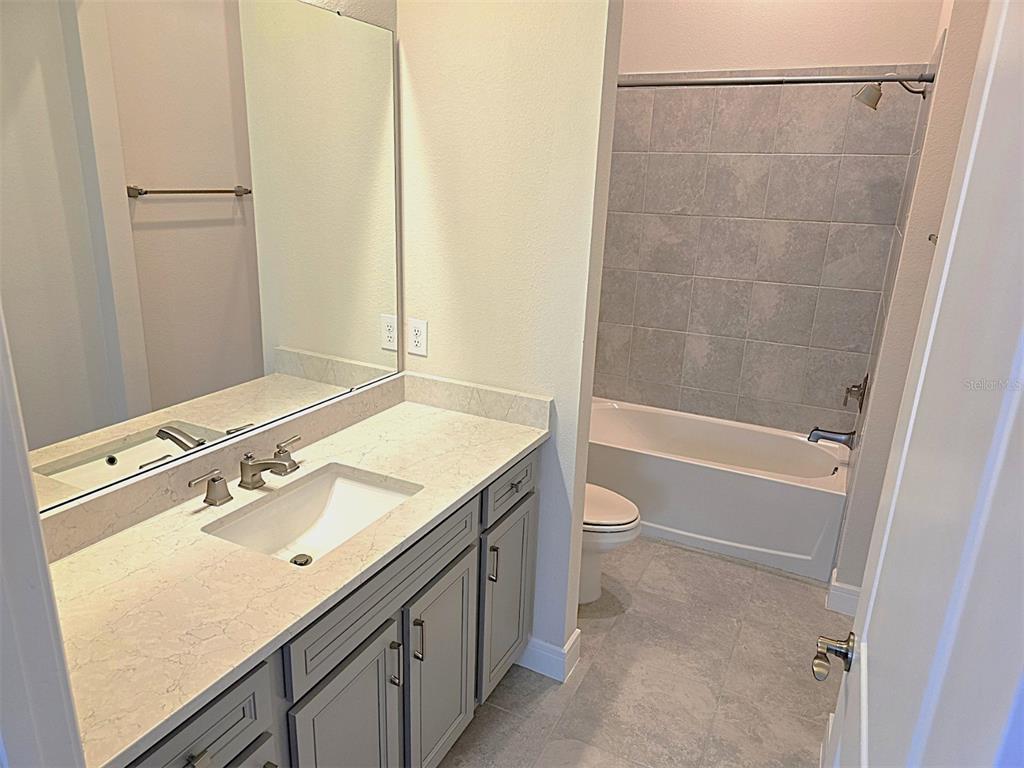 6349 Mossy Oak Road St. Cloud, FL 34771 - Photo 19 of 82 a bathroom with a sink and a mirror