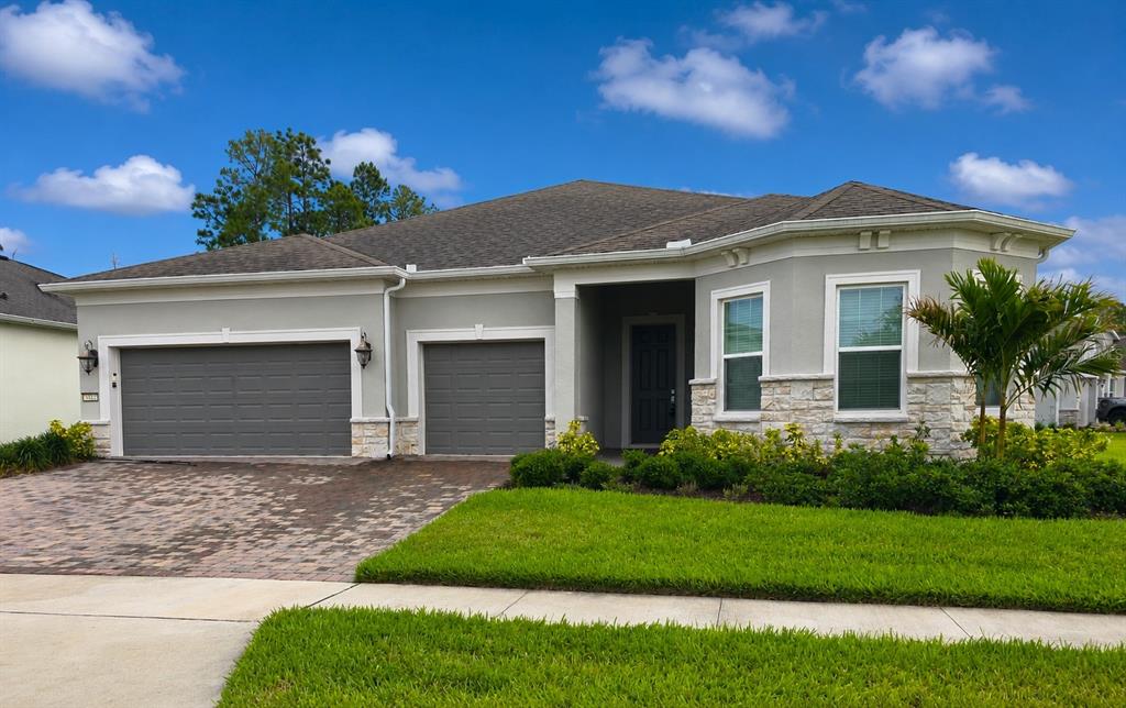 6349 Mossy Oak Road St. Cloud, FL 34771 - Photo 2 of 82 a front view of a house with a garden and yard