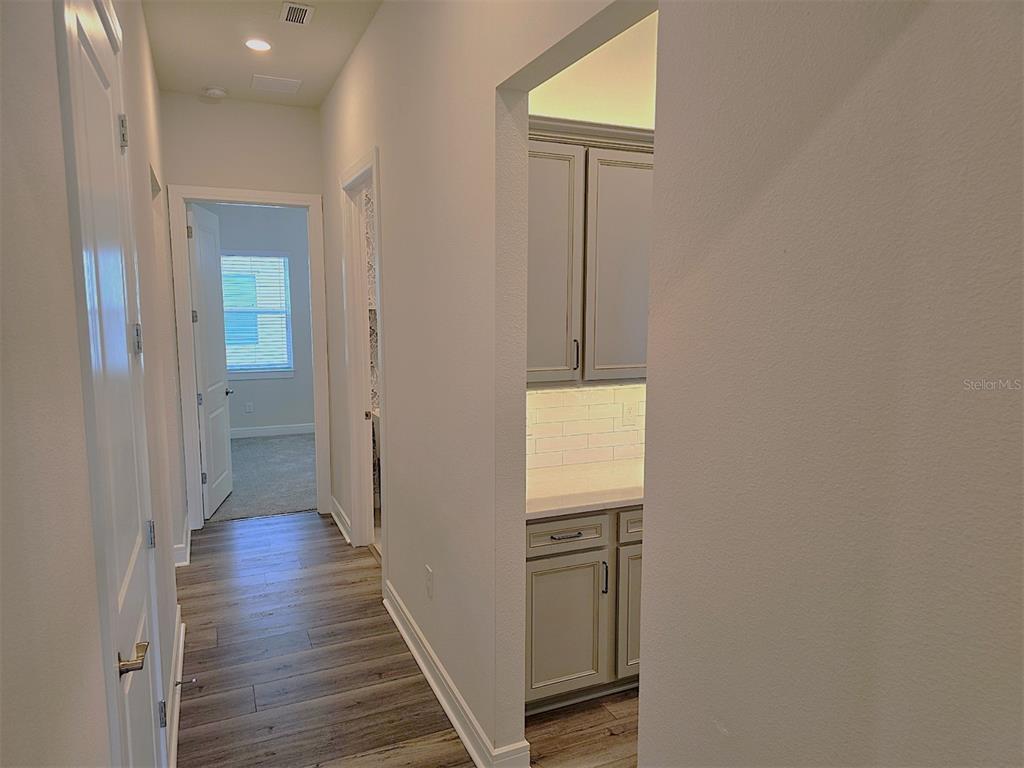 6349 Mossy Oak Road St. Cloud, FL 34771 - Photo 21 of 82 a view of a hallway with wooden floor