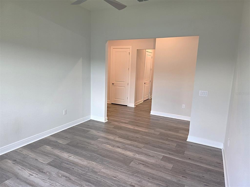 6349 Mossy Oak Road St. Cloud, FL 34771 - Photo 24 of 82 a view of an empty room with wooden floor