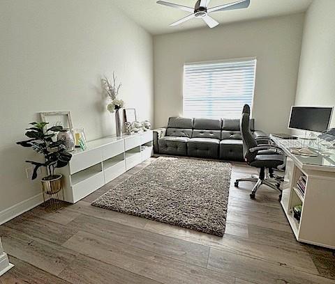 6349 Mossy Oak Road St. Cloud, FL 34771 - Photo 25 of 82 a living room with furniture and a wooden floor