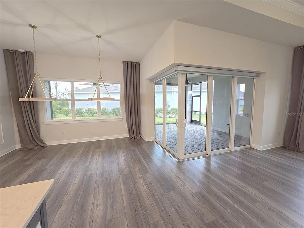 6349 Mossy Oak Road St. Cloud, FL 34771 - Photo 26 of 82 a view of an empty room with wooden floor and a window