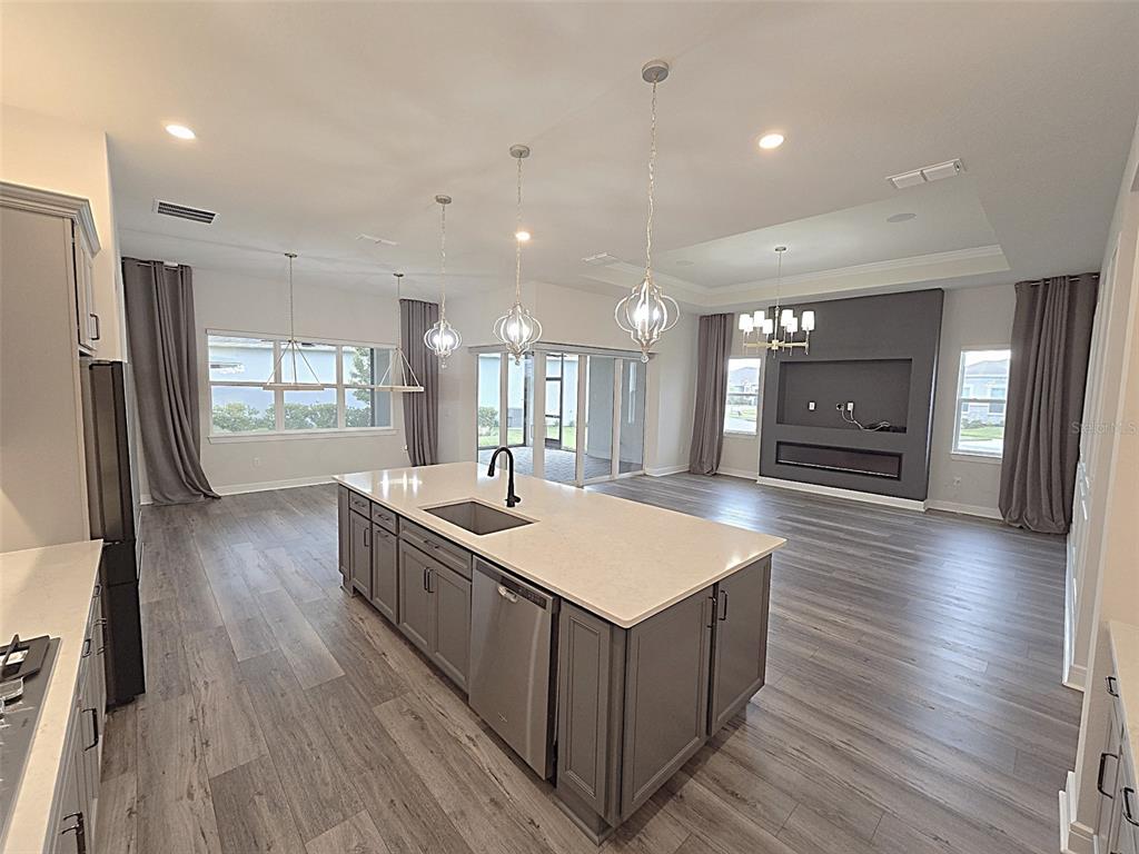 6349 Mossy Oak Road St. Cloud, FL 34771 - Photo 3 of 82 a large kitchen with stainless steel appliances a large counter top a sink a refrigerator and a window