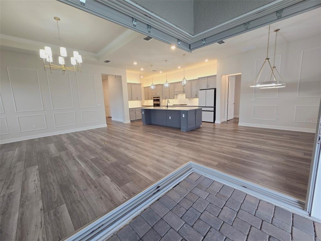 6349 Mossy Oak Road St. Cloud, FL 34771 - Photo 31 of 82 a view of a kitchen with a sink and wooden floor