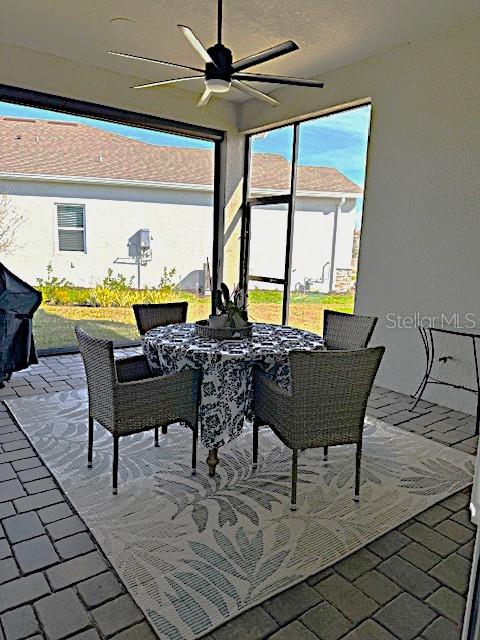 6349 Mossy Oak Road St. Cloud, FL 34771 - Photo 32 of 82 a view of a dinning table and chairs in the terrace