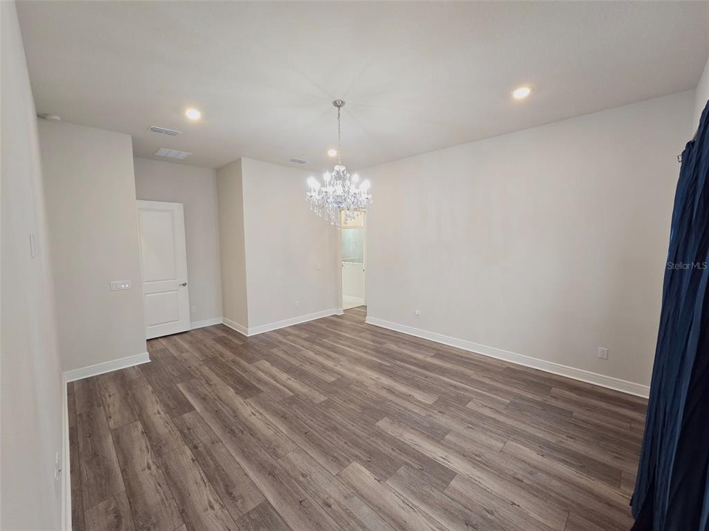 6349 Mossy Oak Road St. Cloud, FL 34771 - Photo 38 of 82 a view of empty room with wooden floor