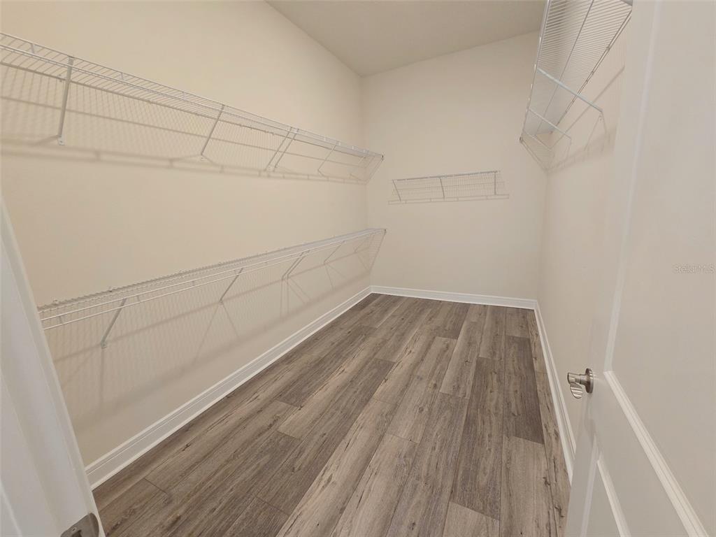 6349 Mossy Oak Road St. Cloud, FL 34771 - Photo 40 of 82 a view of a room with racks on the wall