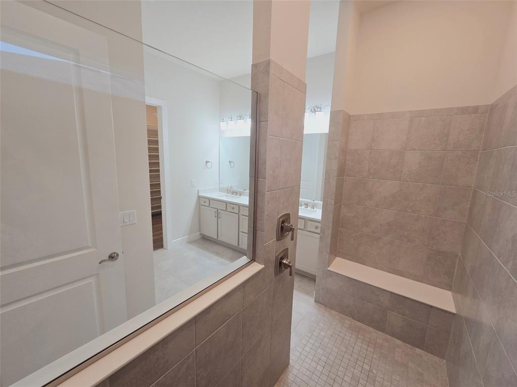 6349 Mossy Oak Road St. Cloud, FL 34771 - Photo 43 of 82 a bathroom with a bathtub and a shower