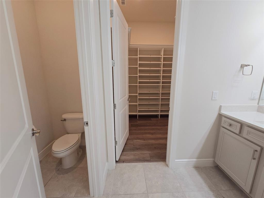 6349 Mossy Oak Road St. Cloud, FL 34771 - Photo 45 of 82 a view of bathroom with a toilet and a sink