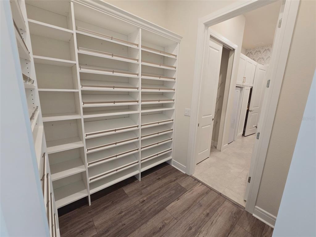 6349 Mossy Oak Road St. Cloud, FL 34771 - Photo 47 of 82 a view of walk in closet with empty racks