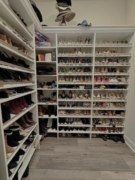 6349 Mossy Oak Road St. Cloud, FL 34771 - Photo 49 of 82 a view of walk in closet with empty racks