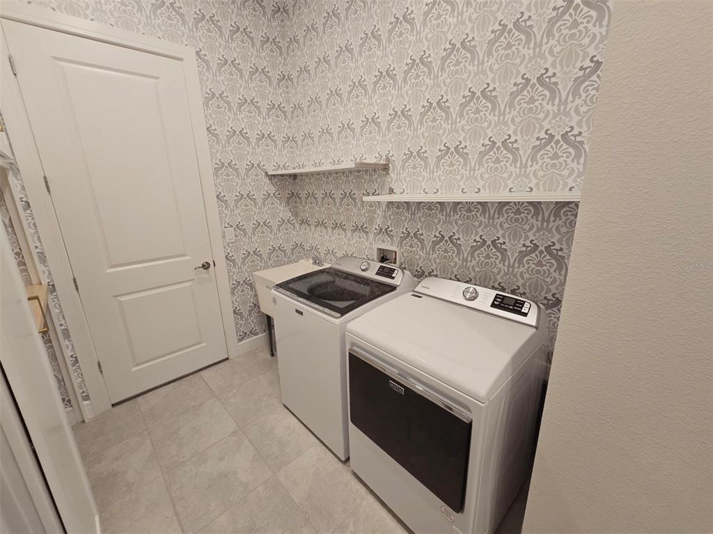 6349 Mossy Oak Road St. Cloud, FL 34771 - Photo 52 of 82 a utility room with dryer and washer