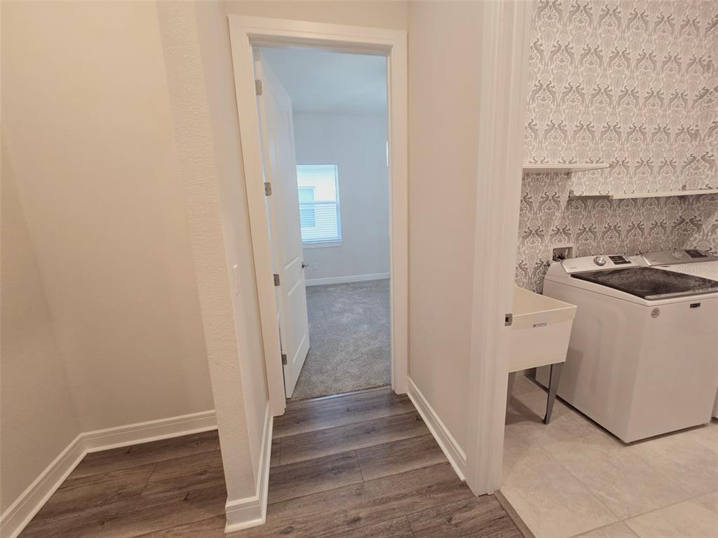 6349 Mossy Oak Road St. Cloud, FL 34771 - Photo 55 of 82 a view of a hallway with wooden floor and a sink