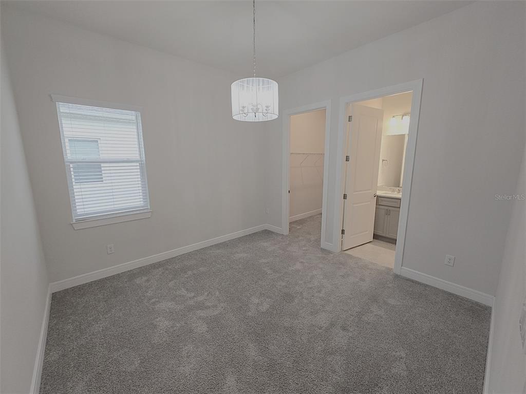 6349 Mossy Oak Road St. Cloud, FL 34771 - Photo 56 of 82 an empty room with windows and a ceiling fan
