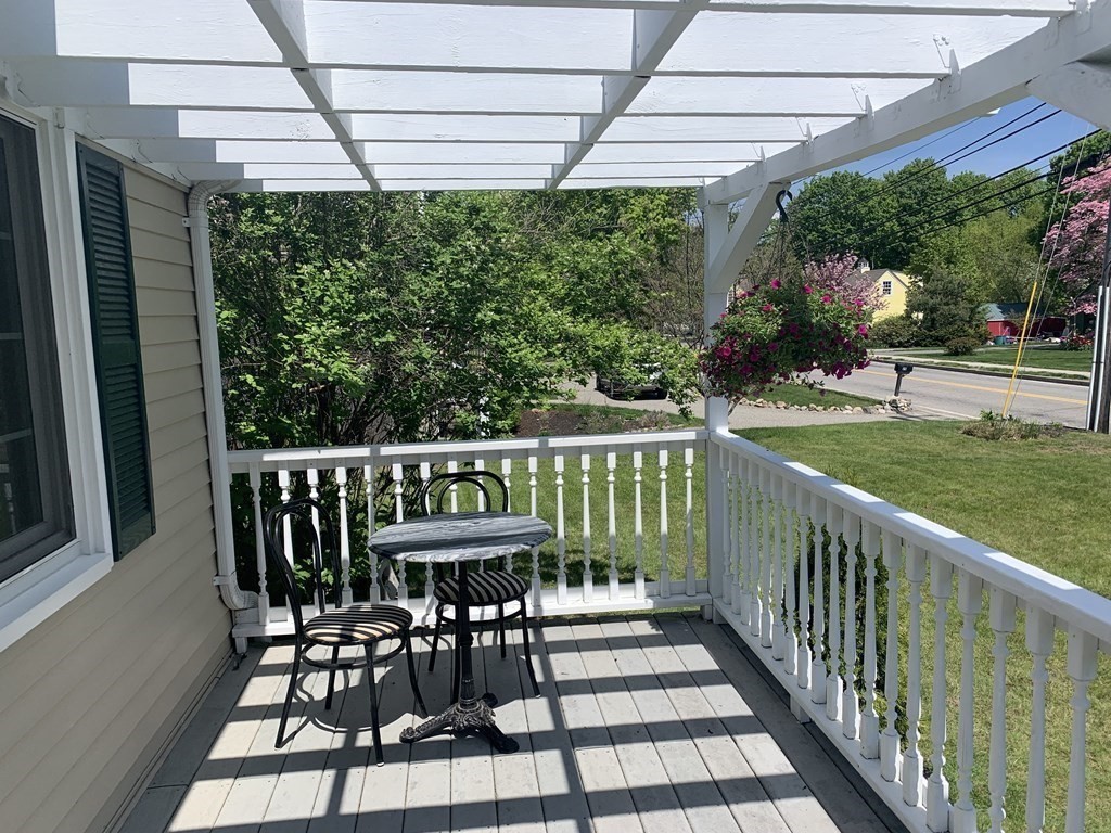 29 Bridge Street Hamilton, MA 01982 - Photo 2 of 16 a view of a chairs and table in the balcony