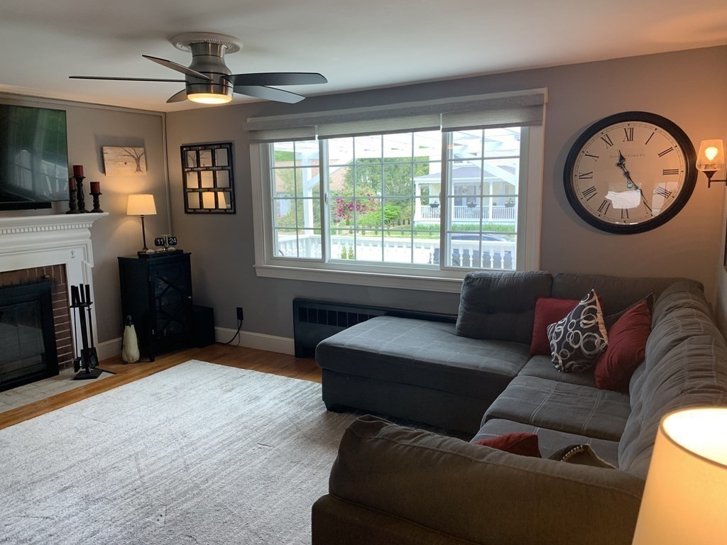 29 Bridge Street Hamilton, MA 01982 - Photo 3 of 16 a living room with furniture a fireplace and a large window