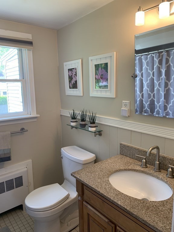 29 Bridge Street Hamilton, MA 01982 - Photo 9 of 16 a bathroom with a granite countertop toilet sink and mirror