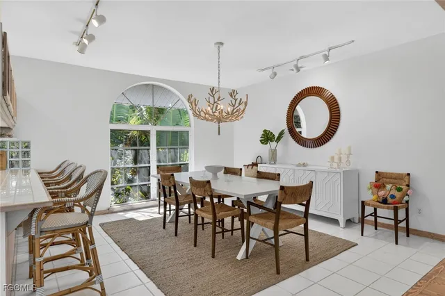 a dining room with furniture a chandelier and a rug