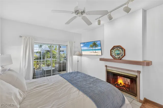 a bedroom with a fireplace and a window