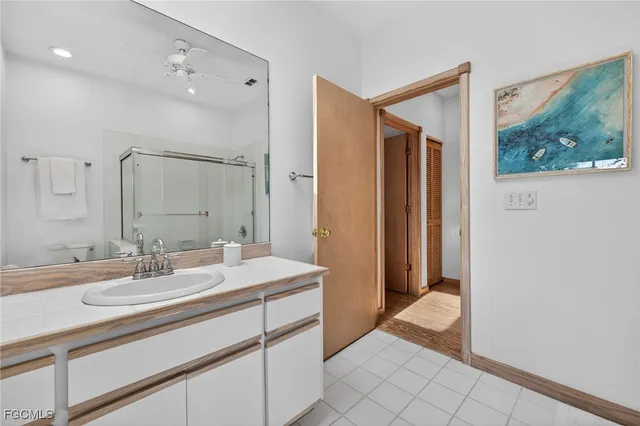 a bathroom with a sink a mirror and a shower