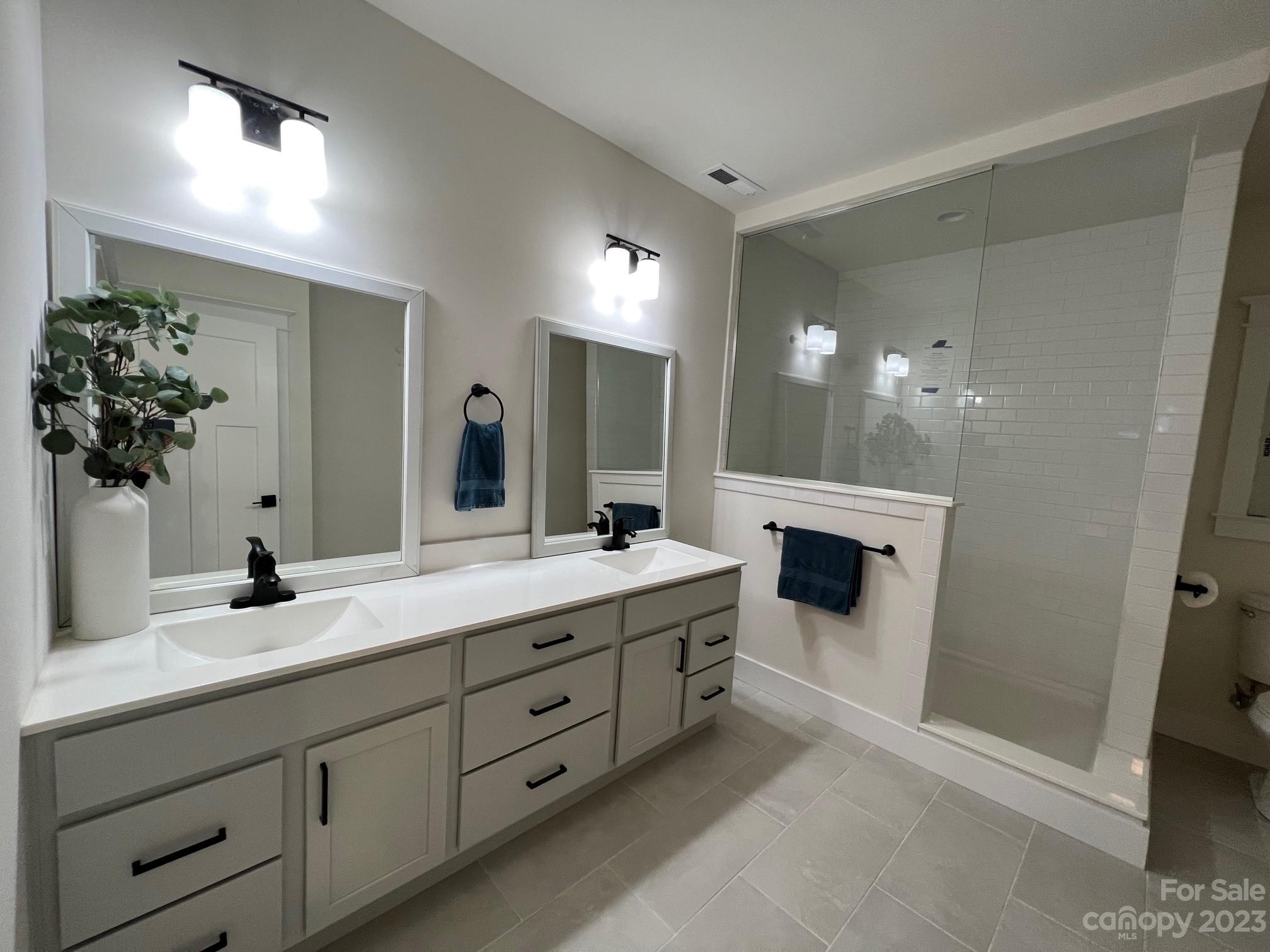 152 Cascade Rdg Road Fairview, NC 28730 - Photo 11 of 18 a bathroom with a double vanity sink and a mirror