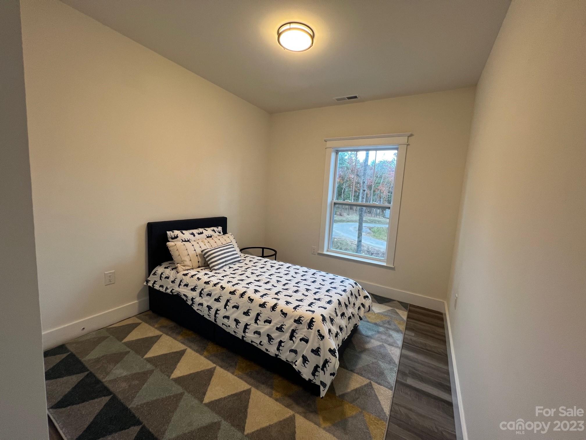 152 Cascade Rdg Road Fairview, NC 28730 - Photo 13 of 18 a bedroom with a bed and window
