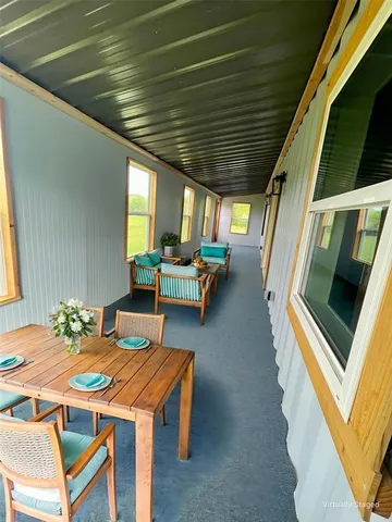 a dining room with furniture and a window