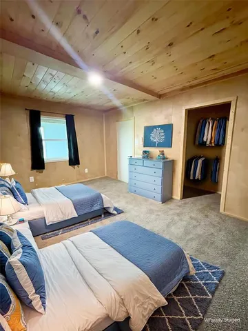 a bedroom with furniture and a flat screen tv