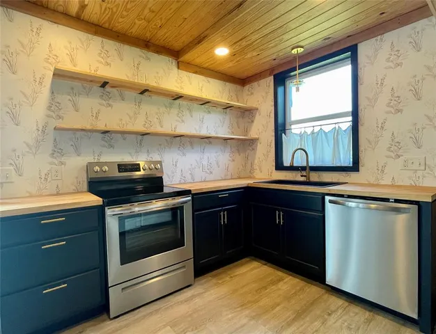 a kitchen with a sink stove and cabinets