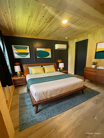 a bedroom with a bed and dresser