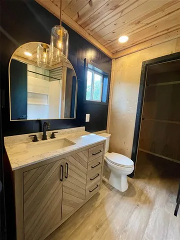 a bathroom with a toilet sink and mirror