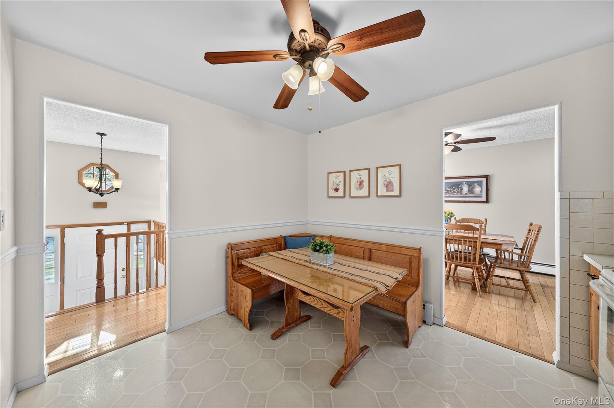 18 Rondack Road Middletown, NY 10941 - Photo 14 of 33 Dining room featuring light tile patterned flooring, a chandelier, and a ceiling fan