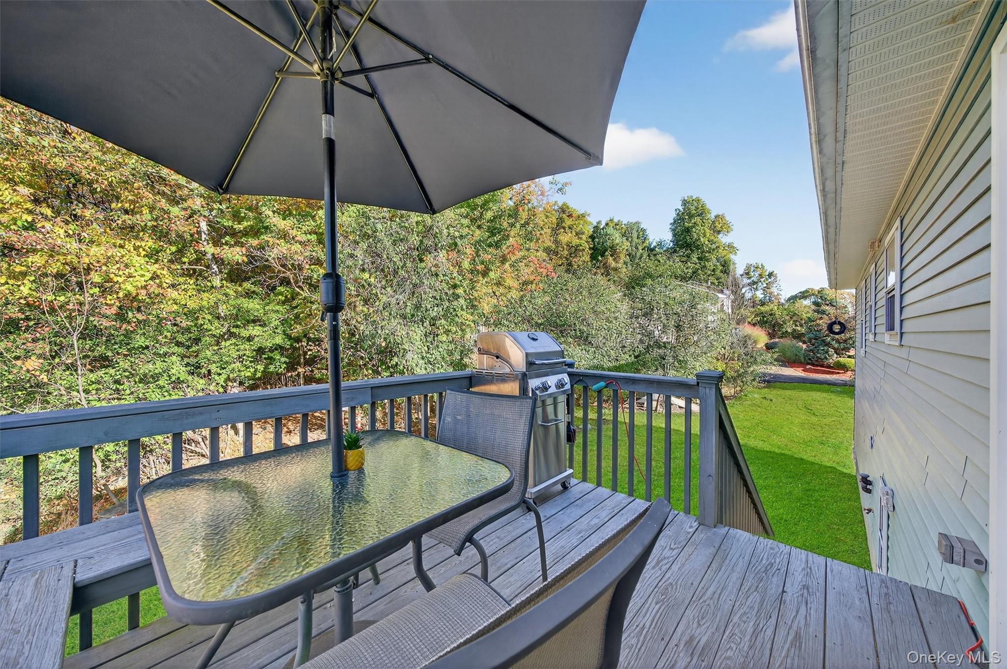 18 Rondack Road Middletown, NY 10941 - Photo 28 of 33 Deck featuring outdoor dining space, a yard, view of scattered trees, and area for grilling