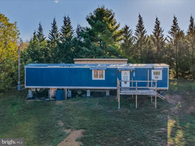 a view of a house with a yard chairs and table