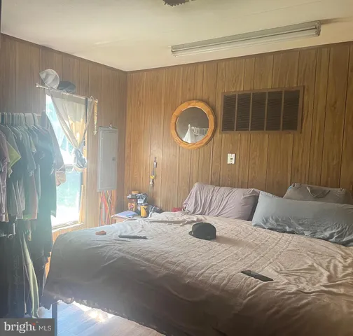 a bedroom with a bed and a mirror