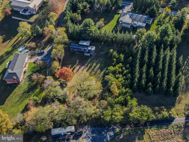 an aerial view of residential house with outdoor space and swimming pool