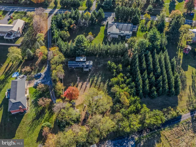 a backyard of a house with a yard and outdoor seating