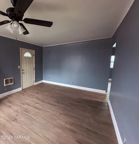 a view of an empty room with a window