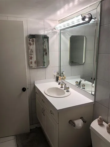 a bathroom with a sink vanity and mirror
