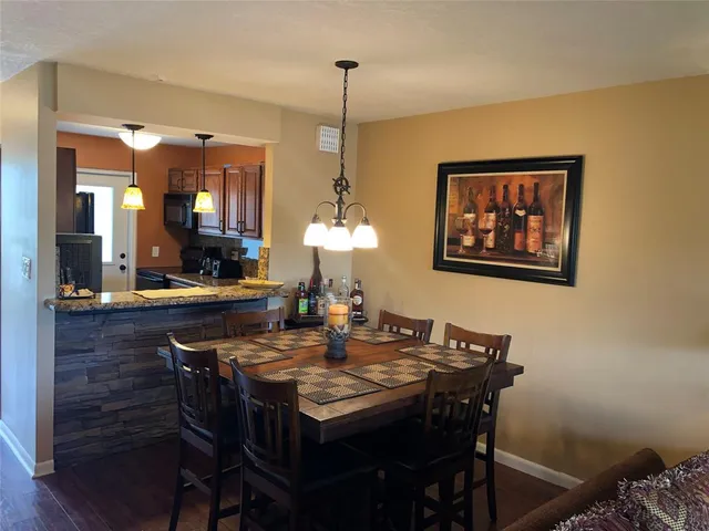 a dining room with a table and chairs