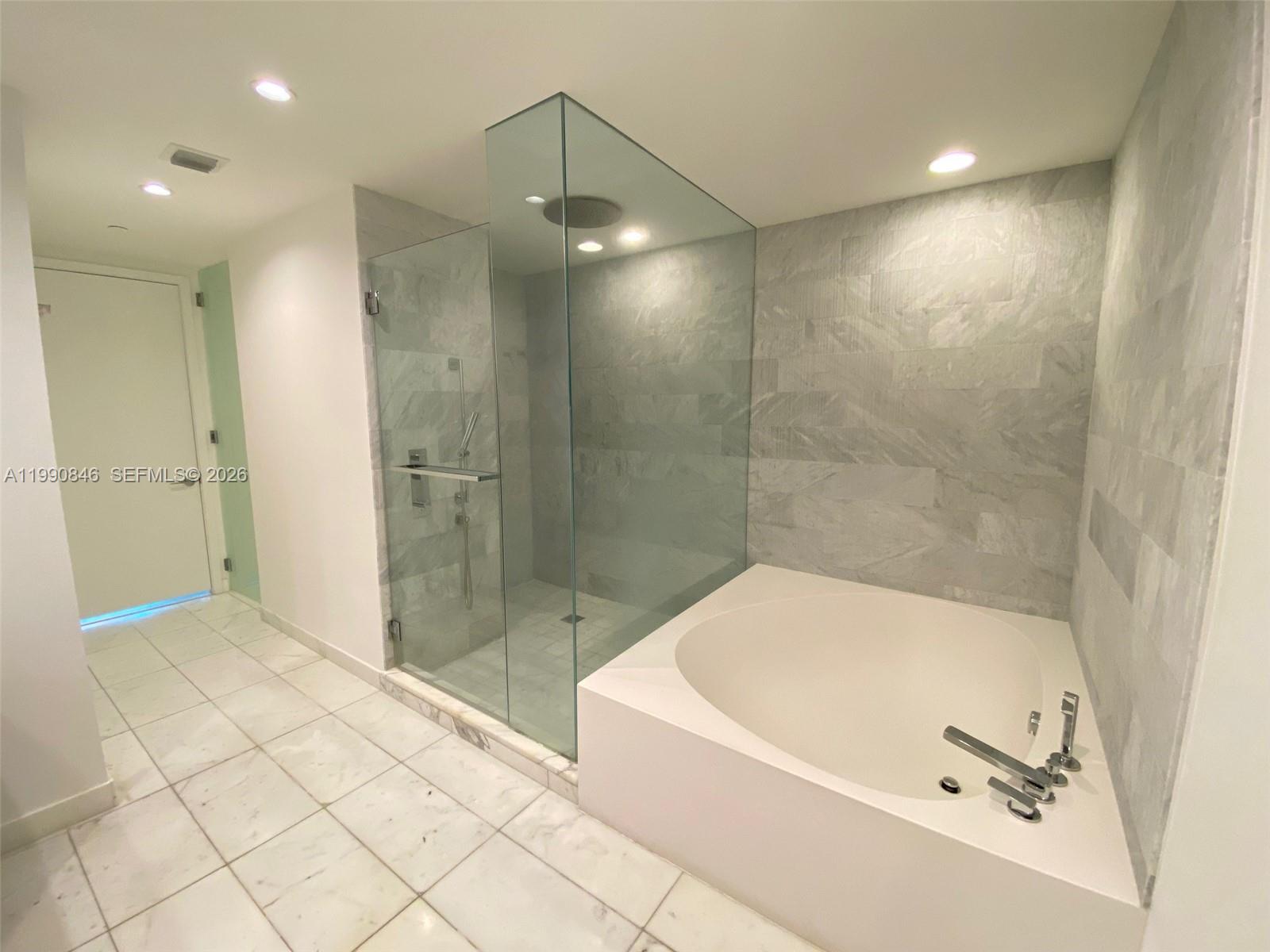 10203 Collins Avenue, Unit 905 Bal Harbour, FL 33154 - Photo 11 of 35 a bathroom with a bathtub and a shower